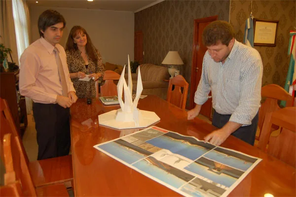 Gustavo Melella mira los planos del monumento. En la mesa, la maqueta.