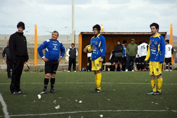Abritro y jugadores miran los desmanes que se producían fuera del campo de juego.